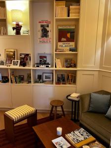 a living room with a couch and a table at Alfred Hotels Paris Gare du Nord- Hôtel Rénové in Paris +19 photos