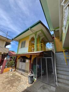 a house with a gate in front of it at Medelaine's Beach Resort in Puerto Galera