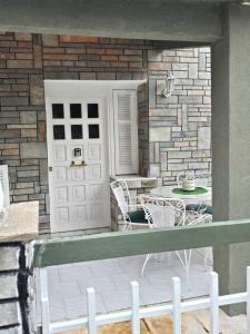 a patio with a table and chairs and a door at Anna-Maria in Nea Kallikrateia +16 photos