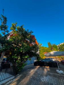 a car parked under an umbrella on a street at Cottage Sandro-Sandro in Kinkisha +8 photos