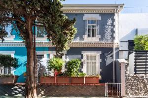 a blue house with plants in front of it at Purple House Accommodations in Cape Town +6 photos
