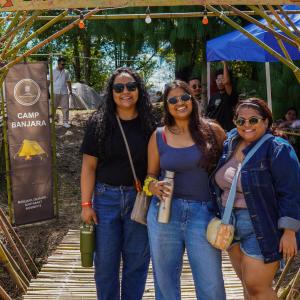 three women posing for a picture at an event at Camp Pineyard Ziro in Ziro