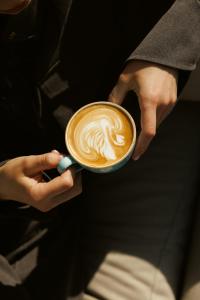 a person is holding a cup of coffee at Hotel Štacija in Kaštela +42 photos