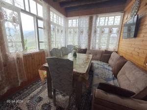 a living room with a table and a couch at Elvin in Küsnǝtqazma