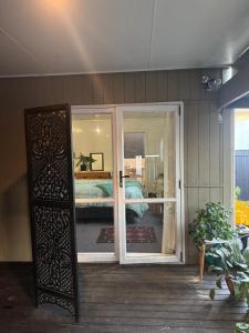 a room with an open door to a bedroom at AB Accomodation in Palmerston North
