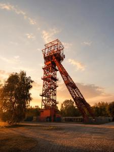 a large metal tower in a parking lot at Industrial Design Studios - Lohnhalle Essen in Essen