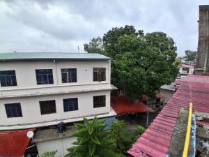 an overhead view of a white building with red roofs at Sandy Homestay in Dehradun