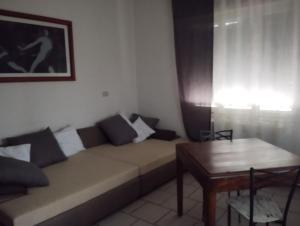 a living room with a couch and a table at Alice House in Arceto