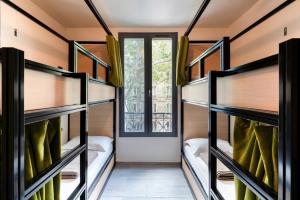 a room with bunk beds with a window at Paris Hostel in Paris