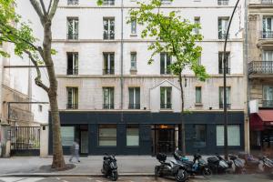 a group of motorcycles parked in front of a building at Paris Hostel in Paris