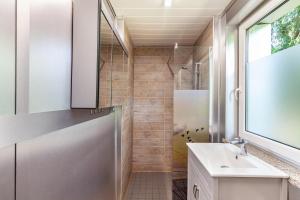 a bathroom with a sink and a shower at Ferienhaus 204 in Zadelsdorf +7 photos