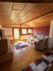 a living room with a couch and a table at Gasthaus Trifelsblick in Wernersberg