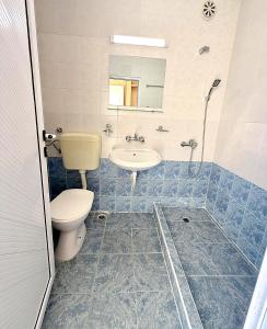 a bathroom with a toilet and a sink at Sunny Steps Hostel in Sunny Beach +3 photos