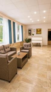 a living room with two couches and a piano at Sunny Steps Hostel in Sunny Beach