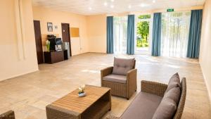 a living room with a couch and chairs and a table at Sunny Steps Hostel in Sunny Beach