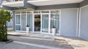 a entrance to a building with glass doors at Sunny Steps Hostel in Sunny Beach