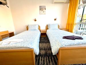 two beds sitting next to each other in a room at Sunny Steps Hostel in Sunny Beach