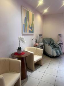 a living room with a couch and a table and chairs at Hotel Am Flughafen in Cologne