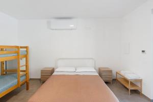 a bedroom with a bed and two bunk beds at Mammina Holiday Home in Casal Velino