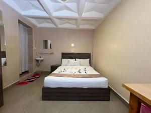 a bedroom with a large bed in a room at Clavina Hotel in Gilgil