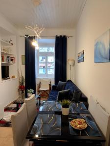a living room with a table and a couch at Blue Sky - Hydra Memories House in Hydra