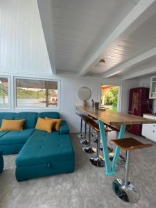 a living room with a blue couch and a table at Viridian Three Boathouse Unique, PERUCAC in Perućac