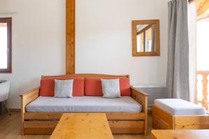 a couch in a living room with a table at Résidence Odalys Les Chalets d'Evian in Évian-les-Bains +44 photos