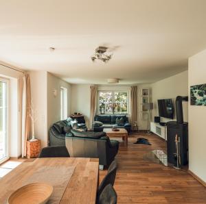 a living room with a couch and a table at Schneekäppchen 2 in Winterberg