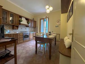 a kitchen with a table and a dining room at Bartahouse in Peccioli