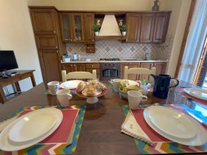a kitchen with a table with plates of food on it at Bartahouse in Peccioli +9 photos