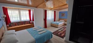 a small bedroom with a bed and a couch at Akay Hotel in Patara