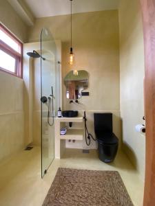 a bathroom with a shower with a toilet and a sink at Surf'n Lanka - Surf School in Weligama +77 photos