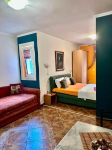 a living room with a bed and a couch at ApartMonte in Budva