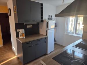 a small kitchen with a blender on a counter at Maison proche bourg in Piégut-Pluviers