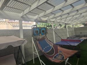 a patio with a basketball hoop and a swing at אחוזת ישי-אברהם in Tiberias