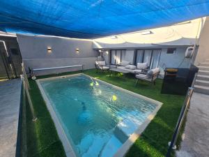 a swimming pool under a tent with a couch at אחוזת ישי-אברהם in Tiberias