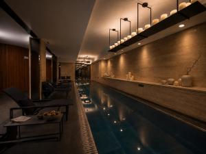 a restaurant with a swimming pool and a bar at Sense Hotel Sofia, a Member of Design Hotels in Sofia