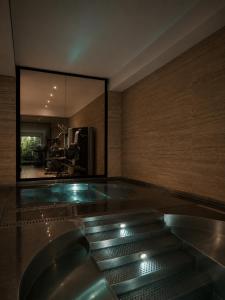 a room with a swimming pool with a glass floor at Sense Hotel Sofia, a Member of Design Hotels in Sofia