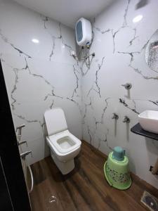 a bathroom with a toilet and a sink at Hotel Sun Park in Ahmedabad +9 photos