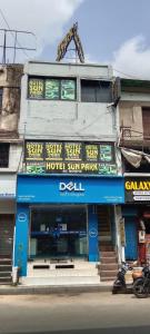 a building with a hotel on the side of the street at Hotel Sun Park in Ahmedabad