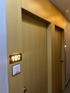 a elevator door with the number on it at Hotel Sun Park in Ahmedabad