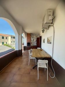 a dining room with a table and chairs and a fan at Villa Julieta in Scalea