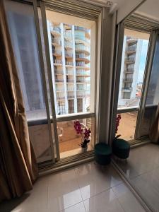 a room with windows and a view of a building at חדר לים הרצליה in Herzliya B