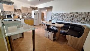 a kitchen with a table and a dining room at Ubytování U Včelek in Horní Dubňany