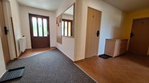 an empty hallway with a door and a mirror at Ubytování U Včelek in Horní Dubňany