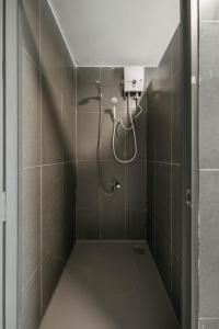 a shower with a shower head in a bathroom at Exia House in Ho Chi Minh City +230 photos