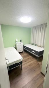 a hospital room with two beds and a window at LE VOLPI Marilleva 1400 in Marilleva