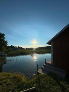 a view of a lake with the sun setting over it at Jennys tent in Saltvik +3 photos