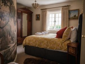 a bedroom with a bed and a window at Lower Colworth Lodge in Chichester