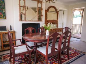 a dining room with a wooden table and chairs at Lower Colworth Lodge in Chichester